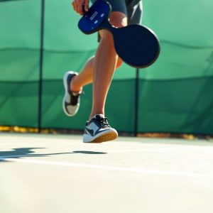 Pickleball player moving quickly on court, dynamic pose.