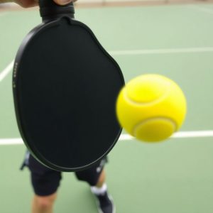 Pickleball player hitting a low dink shot.